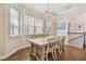 Bright dining room with wood floors, rustic wood table and decorative light fixture, perfect for Gathering gatherings at 6140 Marina Cove S Way, St Petersburg, FL 33712