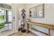 Chic entryway featuring a wooden console table, decorative mirror, and a coat rack, adding style and function at 6140 Marina Cove S Way, St Petersburg, FL 33712