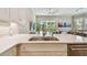 Modern kitchen with a sink overlooking the living room and balcony at 6140 Marina Cove S Way, St Petersburg, FL 33712