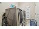 Modern laundry room featuring stainless steel washer and dryer, overhead storage cabinets, and ample workspace at 6140 Marina Cove S Way, St Petersburg, FL 33712