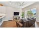 Inviting living room with hardwood floors, sliding glass doors leading to a balcony, and a comfortable leather sofa at 6140 Marina Cove S Way, St Petersburg, FL 33712
