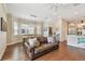 Open-concept living room and dining area featuring hardwood floors and a modern chandelier at 6140 Marina Cove S Way, St Petersburg, FL 33712