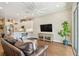Stylish living room featuring hardwood floors, modern entertainment center, and open flow into the kitchen, creating a cozy atmosphere at 6140 Marina Cove S Way, St Petersburg, FL 33712