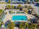 Relaxing pool area with lounge chairs, palm trees, and tiki huts for shade at 6140 Marina Cove S Way, St Petersburg, FL 33712