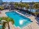 Refreshing pool with lounge chairs, palm trees, and inviting blue water at 6140 Marina Cove S Way, St Petersburg, FL 33712