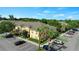 Aerial view of exteriors with parking and lush trees at 6250 Maisie Rd, Zephyrhills, FL 33542