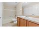 Bathroom featuring wood vanity, tile flooring, soaking tub, and neutral colors at 6250 Maisie Rd, Zephyrhills, FL 33542