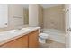 Bathroom featuring wood vanity, tile flooring, soaking tub, and neutral colors at 6250 Maisie Rd, Zephyrhills, FL 33542