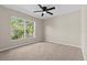 Neutral bedroom featuring carpet and a window providing natural light at 6250 Maisie Rd, Zephyrhills, FL 33542