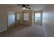 Bright bedroom with carpeted floor, ceiling fan, and large mirrored closet at 6250 Maisie Rd, Zephyrhills, FL 33542
