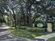 Eiland Park Townhomes entrance sign surrounded by trees and lush landscaping at 6250 Maisie Rd, Zephyrhills, FL 33542
