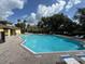 Community pool with lounge chairs and well maintained patio at 6250 Maisie Rd, Zephyrhills, FL 33542