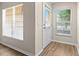 Inviting entryway featuring wood-look flooring and ample natural light through the windows at 6250 Maisie Rd, Zephyrhills, FL 33542