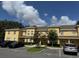 Exterior view of townhome complex with parking and landscaping at 6250 Maisie Rd, Zephyrhills, FL 33542
