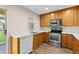 Functional kitchen featuring wood cabinets, stainless steel appliances, and a dishwasher at 6250 Maisie Rd, Zephyrhills, FL 33542