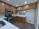 Well-lit kitchen featuring stainless steel appliances, light countertops, and warm wood cabinetry at 6250 Maisie Rd, Zephyrhills, FL 33542