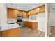 Well-lit kitchen with stainless steel appliances and wood cabinets at 6250 Maisie Rd, Zephyrhills, FL 33542