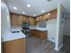 Well-lit kitchen with laminate flooring, stainless steel appliances, and new countertops at 6250 Maisie Rd, Zephyrhills, FL 33542
