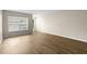 Bright and airy living room with wood-look flooring and baseboards at 6250 Maisie Rd, Zephyrhills, FL 33542