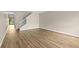 Spacious living room featuring wood-look flooring, baseboards, and natural lighting at 6250 Maisie Rd, Zephyrhills, FL 33542