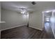 Comfortable living room featuring ceiling fan and hardwood floors, with view of hallway at 6250 Maisie Rd, Zephyrhills, FL 33542