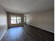 Bright living room with hardwood floors and natural light from large window at 6250 Maisie Rd, Zephyrhills, FL 33542
