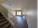 Open living room with stairs and new laminate flooring at 6250 Maisie Rd, Zephyrhills, FL 33542