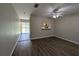 View of the living room with laminate flooring and view of the kitchen at 6250 Maisie Rd, Zephyrhills, FL 33542