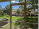 View from screened patio showing green lawn and neighboring townhomes with manicured landscaping at 6250 Maisie Rd, Zephyrhills, FL 33542
