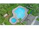 Aerial view of community pool with lounge chairs and spa at 6250 Maisie Rd, Zephyrhills, FL 33542