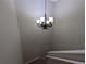 Stairwell with a decorative chandelier hanging from the high ceiling at 6250 Maisie Rd, Zephyrhills, FL 33542