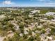 Aerial perspective of a property in a verdant community, near a waterway, and close to recreational amenities at 653 E Spruce St, Tarpon Springs, FL 34689