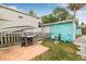 Outdoor space includes a grill, patio, chairs, and lush green lawn, perfect for relaxation and entertainment at 653 E Spruce St, Tarpon Springs, FL 34689