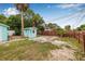 Spacious backyard with a small shed, mature trees, and plenty of room for outdoor activities at 653 E Spruce St, Tarpon Springs, FL 34689