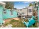 Charming backyard with patio, grill, lawn, and colorful chairs, creating an inviting outdoor atmosphere at 653 E Spruce St, Tarpon Springs, FL 34689