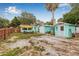Wide backyard features sheds, mature trees, and ample space for outdoor enjoyment and potential projects at 653 E Spruce St, Tarpon Springs, FL 34689