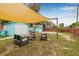 Relaxing backyard featuring shade sails, a privacy fence, and outdoor seating at 653 E Spruce St, Tarpon Springs, FL 34689