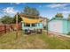 Cozy backyard with seating area under a shade sail, perfect for relaxing and entertaining friends at 653 E Spruce St, Tarpon Springs, FL 34689