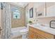 Well-lit bathroom features a shower-tub combo, decorative tile, and classic fixtures at 653 E Spruce St, Tarpon Springs, FL 34689
