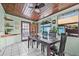 Cozy dining room boasts tile floors, lots of natural light, and space for entertaining at 653 E Spruce St, Tarpon Springs, FL 34689