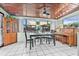 Bright dining room featuring tile floors, wood-paneled ceiling, and an abundance of natural light at 653 E Spruce St, Tarpon Springs, FL 34689