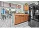 Bright kitchen with wooden cabinets and view to the dining room at 653 E Spruce St, Tarpon Springs, FL 34689