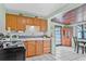 Bright kitchen with wooden cabinets and view to the dining room at 653 E Spruce St, Tarpon Springs, FL 34689