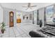 Bright living room with tile floors, large windows, and a comfortable leather sofa at 653 E Spruce St, Tarpon Springs, FL 34689