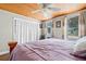 Comfortable bedroom showcasing a wood-paneled ceiling and ample natural light at 653 E Spruce St, Tarpon Springs, FL 34689