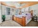 Spacious bedroom featuring a large bed, wood-paneled ceiling and multiple windows at 653 E Spruce St, Tarpon Springs, FL 34689