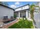 Backyard featuring brick pathway, screened-in patio, and well-manicured lawn at 7307 S Trask St, Tampa, FL 33616