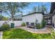 Spacious backyard with brick pathway, green lawn, and white vinyl fence at 7307 S Trask St, Tampa, FL 33616