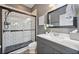 Modern bathroom with tiled walk-in shower, sleek vanity, framed mirror, and contemporary fixtures at 7307 S Trask St, Tampa, FL 33616