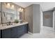 Well-lit bathroom featuring double sinks, a modern vanity, and marble floors for a spa-like experience at 7307 S Trask St, Tampa, FL 33616